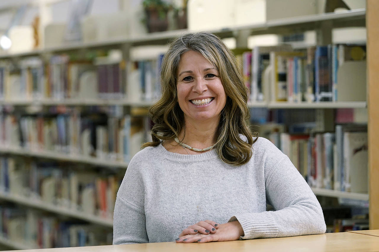 Middle-school counselor Shanon Baker poses for a photo in the school’s library Wednesday in Sammamish. A master’s degree and a full-time job weren’t enough to help Baker land an apartment she could afford in Seattle’s east-side suburbs. (AP Photo/Elaine Thompson)