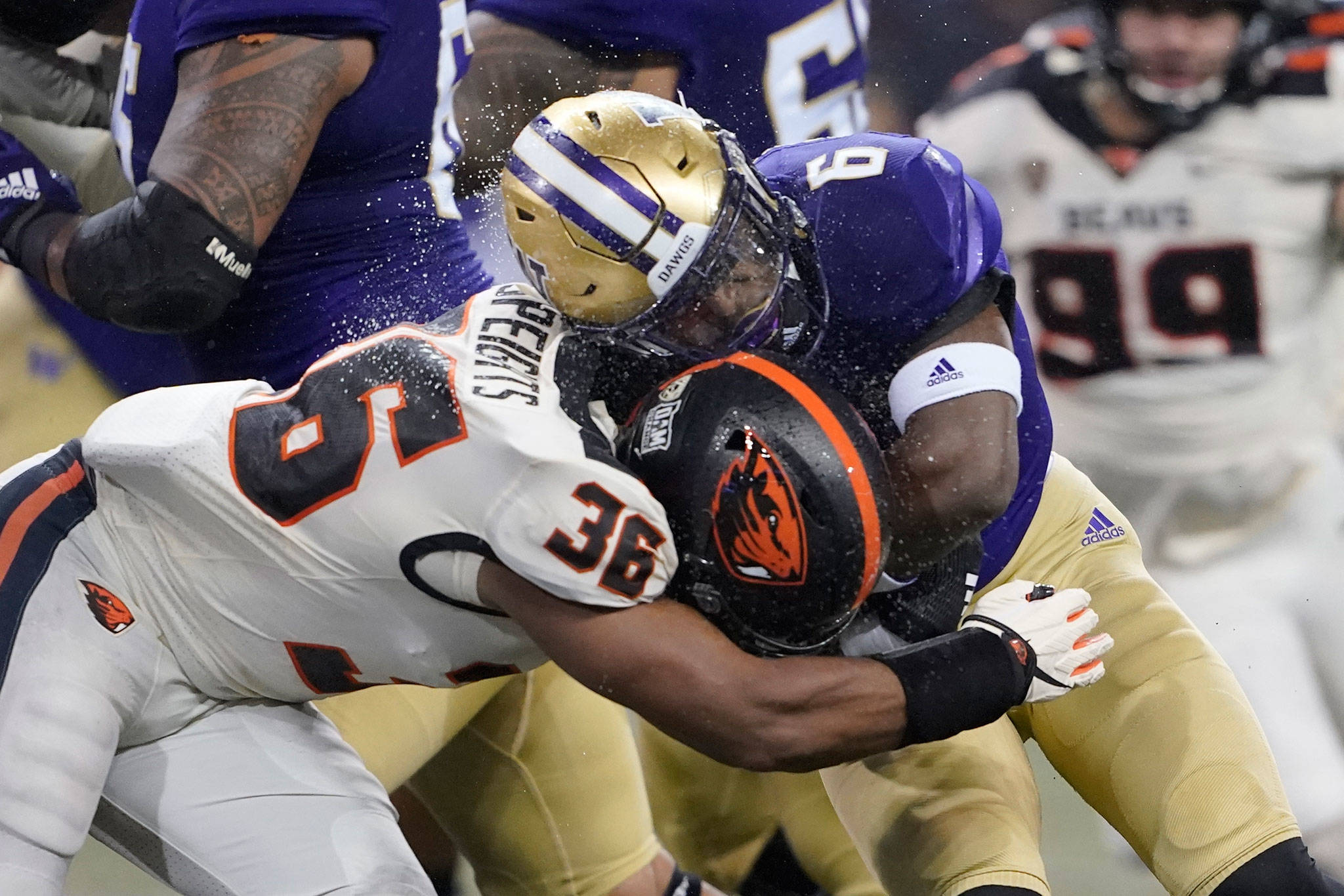 Washington running back Richard Newton collides with Oregon State linebacker Omar Speights during the first half of a game Nov. 14, 2020, in Seattle. (AP Photo/Ted S. Warren)