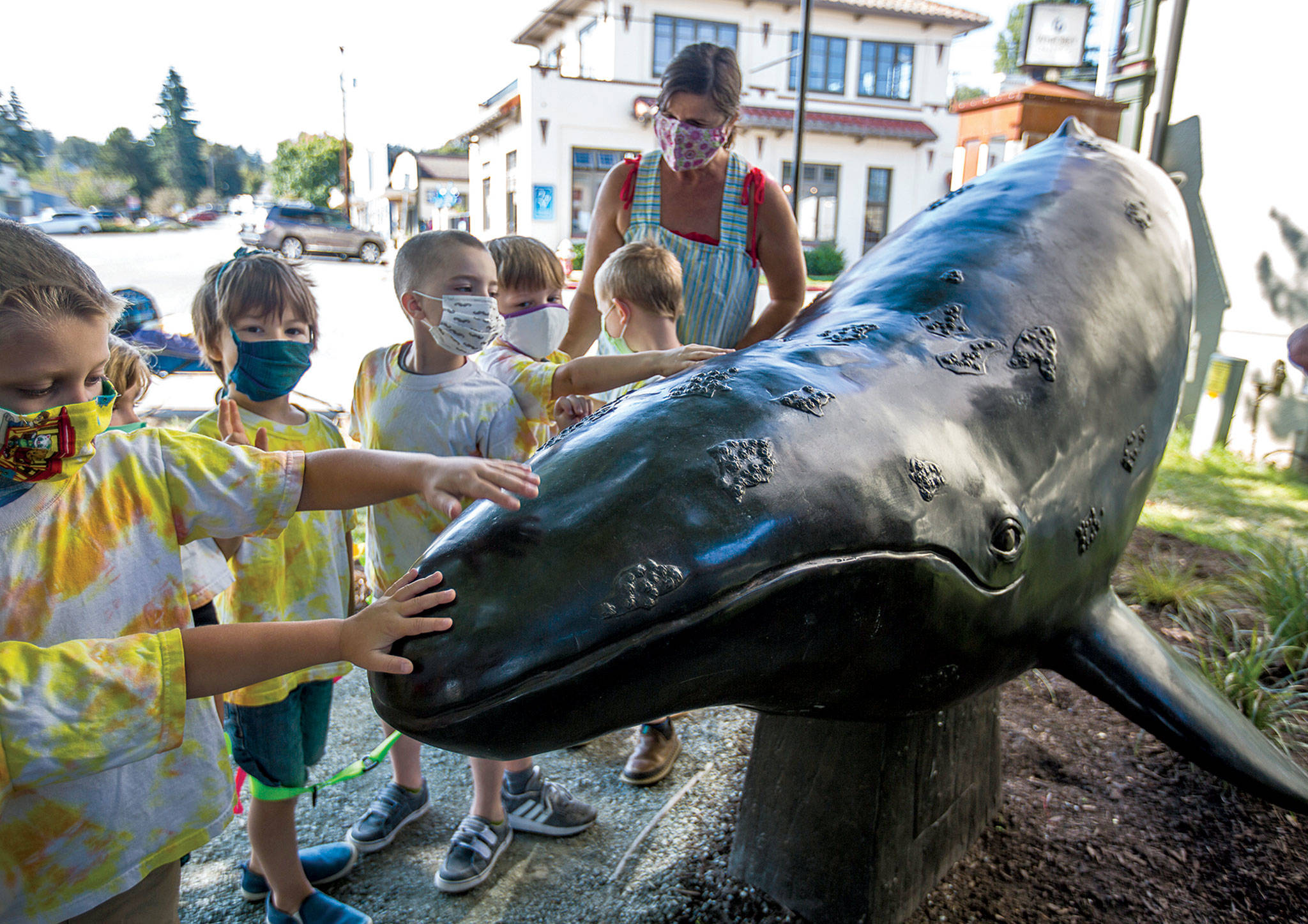 A daycare group admires the new whale sculpture by Georgia Gerber in Langley. (Olivia Vanni / The Herald)