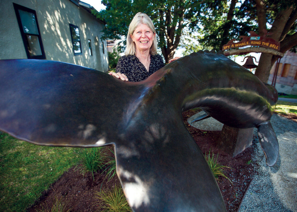 Georgia Gerber with her whale statue on display along First Street in Langley. (Olivia Vanni / The Herald)
