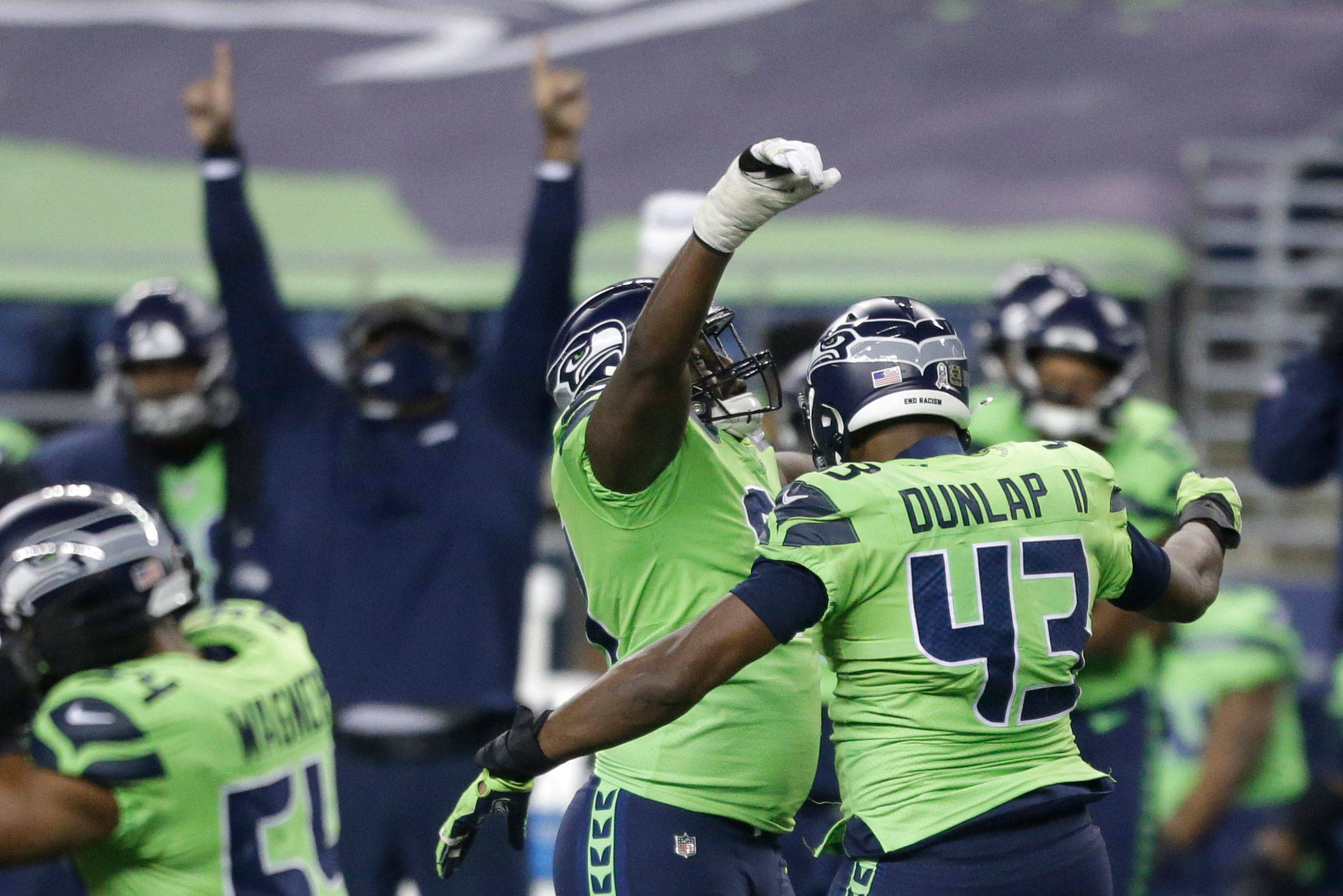 Seahawks defensive end Carlos Dunlap (43) celebrates with defensive end L.J. Collier after Dunlap sacked Cardinals quarterback Kyler Murray late in the second half of a game Thursday night in Seattle. The Seahawks won 28-21. (AP Photo/Lindsey Wasson)