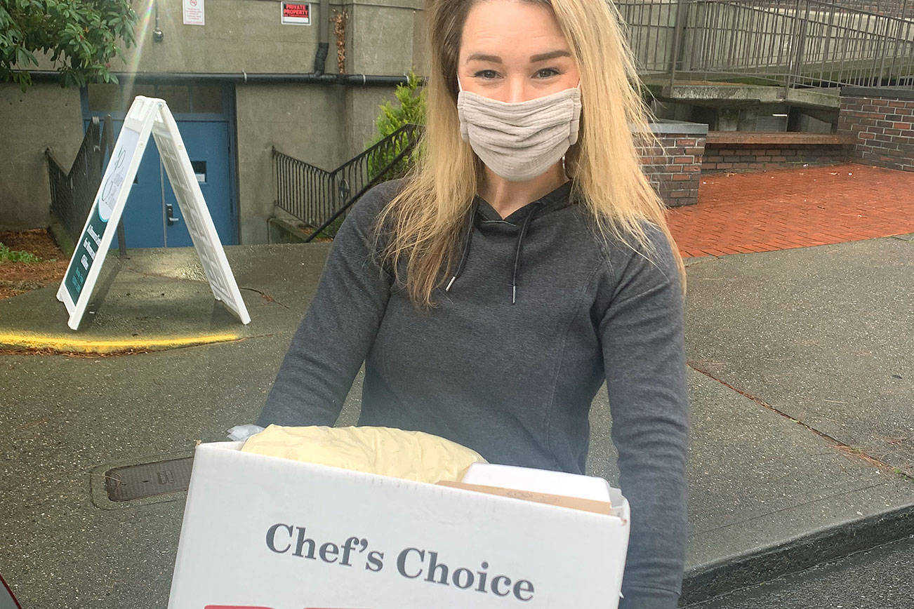 Sharon Olson gets ready to hand out meals for Thanksgiving. She and her husband Matt Olson have provided enough food to feed about 160 people this year. (Contributed photo)