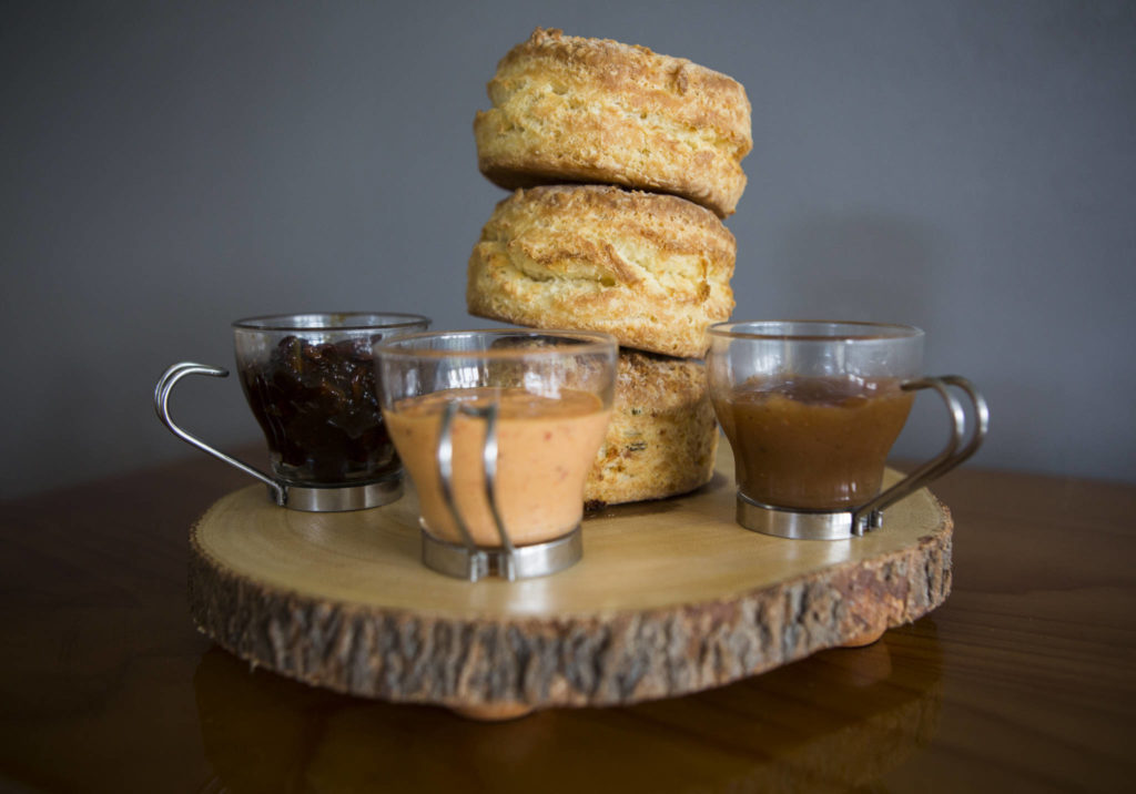 Biscuit Bean offers buttermilk and cheddar onion biscuits, along with a long list of spreads, including (from left) bacon jam, Mama’s Lil’ Pepper aioli and apple butter. (Olivia Vanni / The Herald)
