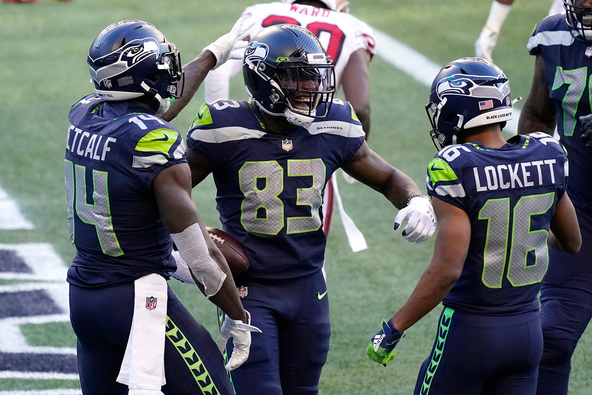 Seahawks wide receiver David Moore (83) celebrates with DK Metcalf (left) and Tyler Lockett (16), after Moore scored a touchdown against the San Francisco 49ers during a game Nov. 1, 2020, in Seattle. (AP Photo/Elaine Thompson)