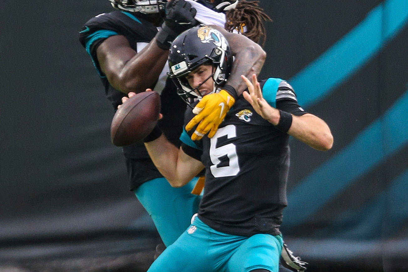 Pittsburgh Steelers linebacker Bud Dupree (48) pushes past Jacksonville Jaguars offensive tackle Cam Robinson (74), left, to sack quarterback Jake Luton (6) during the second half of an NFL football game, Sunday, Nov. 22, 2020, in Jacksonville, Fla. (AP Photo/Gary McCullough)