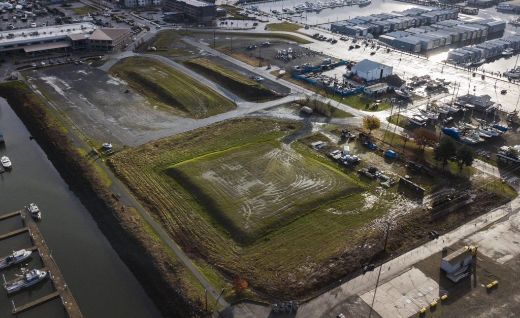 Mounds of fill dirt at the Port of Everett Marina, to be used to help elevate certain sites around the waterfront in anticipation of rising sea levels. (Olivia Vanni / The Herald)
