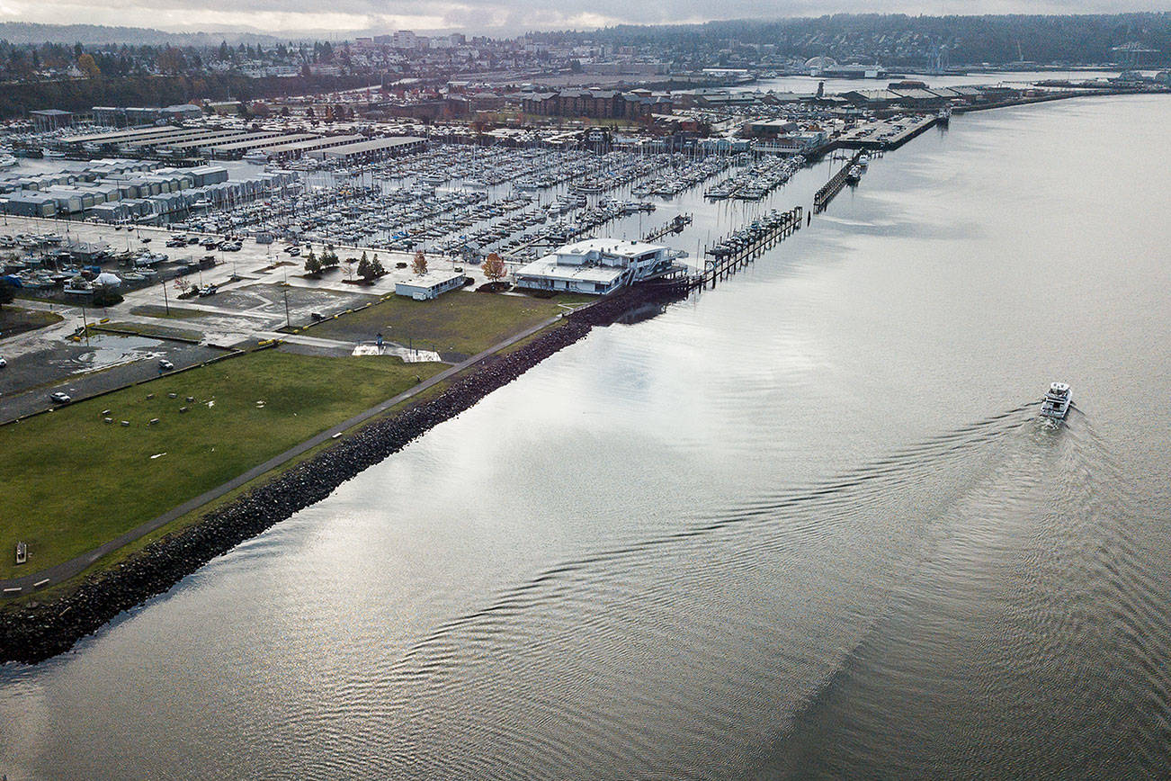 A boat drives out of the Port of Everett Marina in front of Boxcar Park, which is one of the sites set to be elevated in preparation for rising sea levels on Wednesday, Nov. 25, 2020 in Everett, Wa. (Olivia Vanni / The Herald)