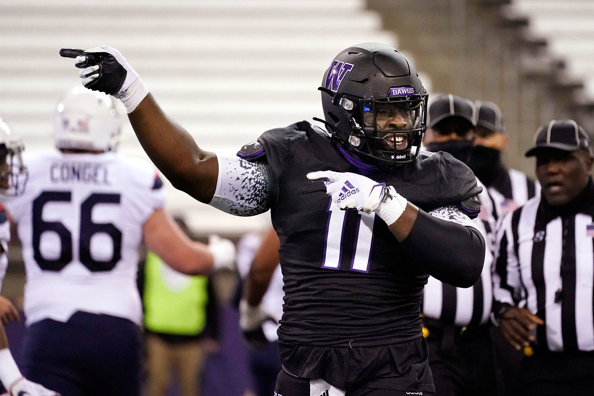 Washington’s Josiah Bronson motions after the team recovered an Arizona fumble during a game Nov. 21, 2020, in Seattle. (AP Photo/Elaine Thompson)