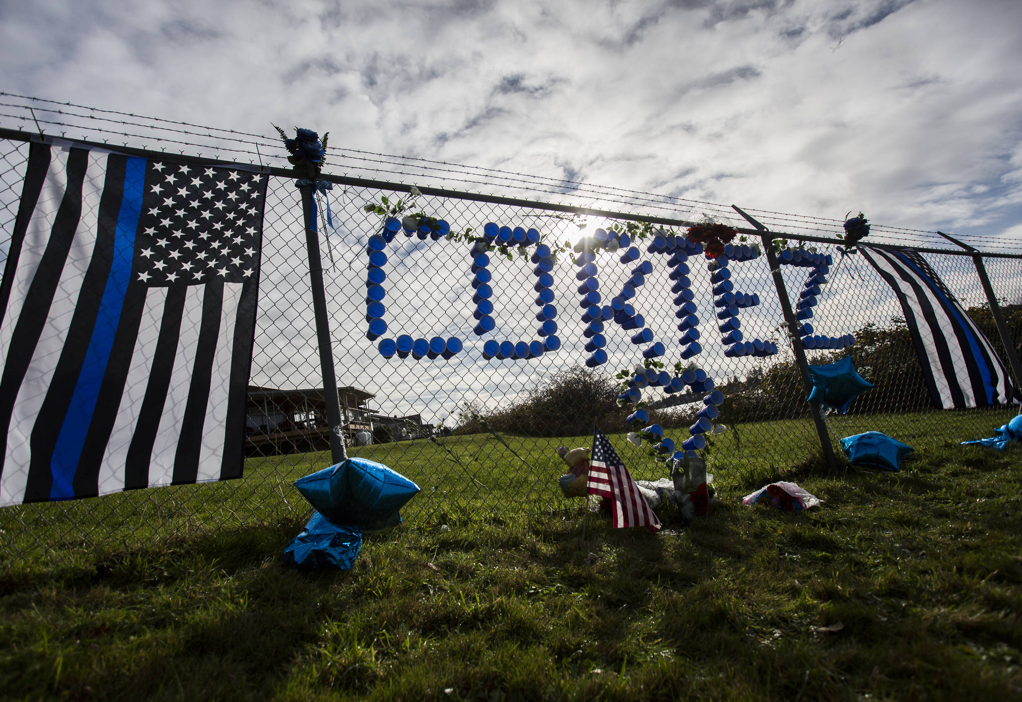 A memorial for Tulalip Tribal Police officer Charlie Cortez at the Tulalip Marina on Wednesday. (Olivia Vanni / The Herald)
