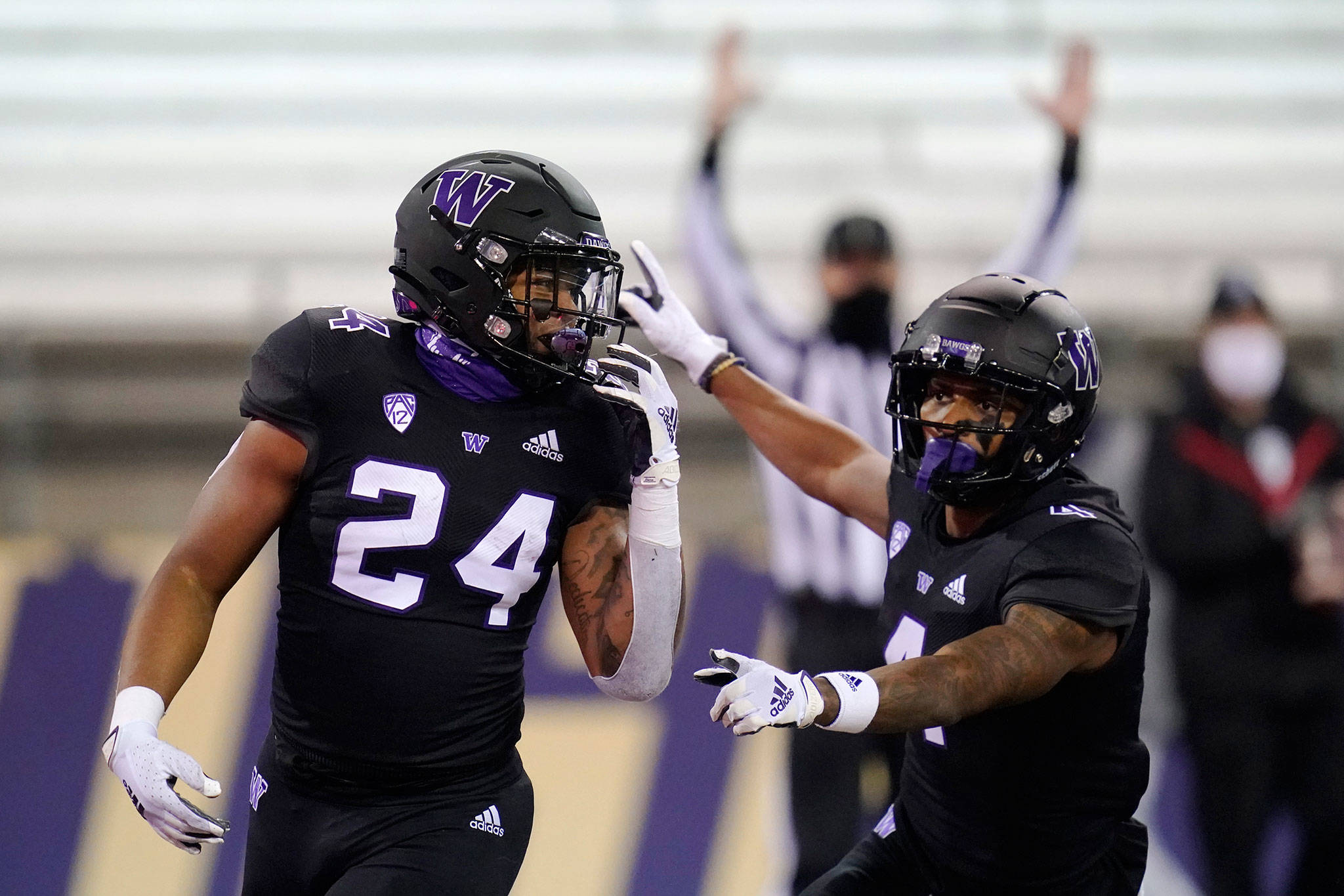 Washington’s Kamari Pleasant (24) celebrates his touchdown with Terrell Bynum during the second half of a game against Arizona on Nov. 21, 2020, in Seattle. (AP Photo/Elaine Thompson)