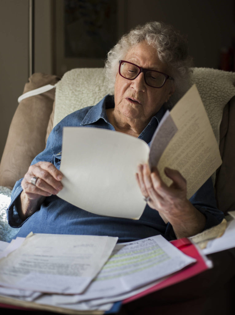 Janet Taggart flips through old documents related to the work she did to change the public education system to include students with disabilities. (Olivia Vanni / The Herald)
