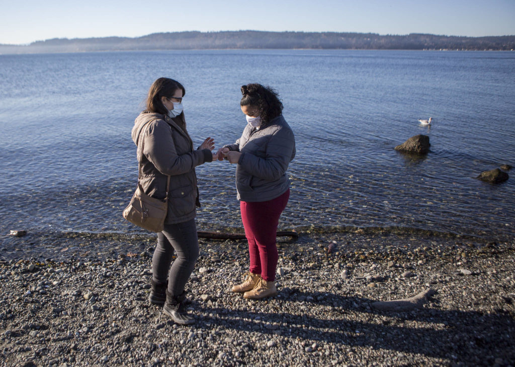 Jessica Parsons (left) and Little Sister Aliyah Velasquez, 13, walk along Mukilteo Beach during one of their Big Sister Little Sister hangouts Dec. 2 in Mukilteo. (Olivia Vanni / The Herald)
