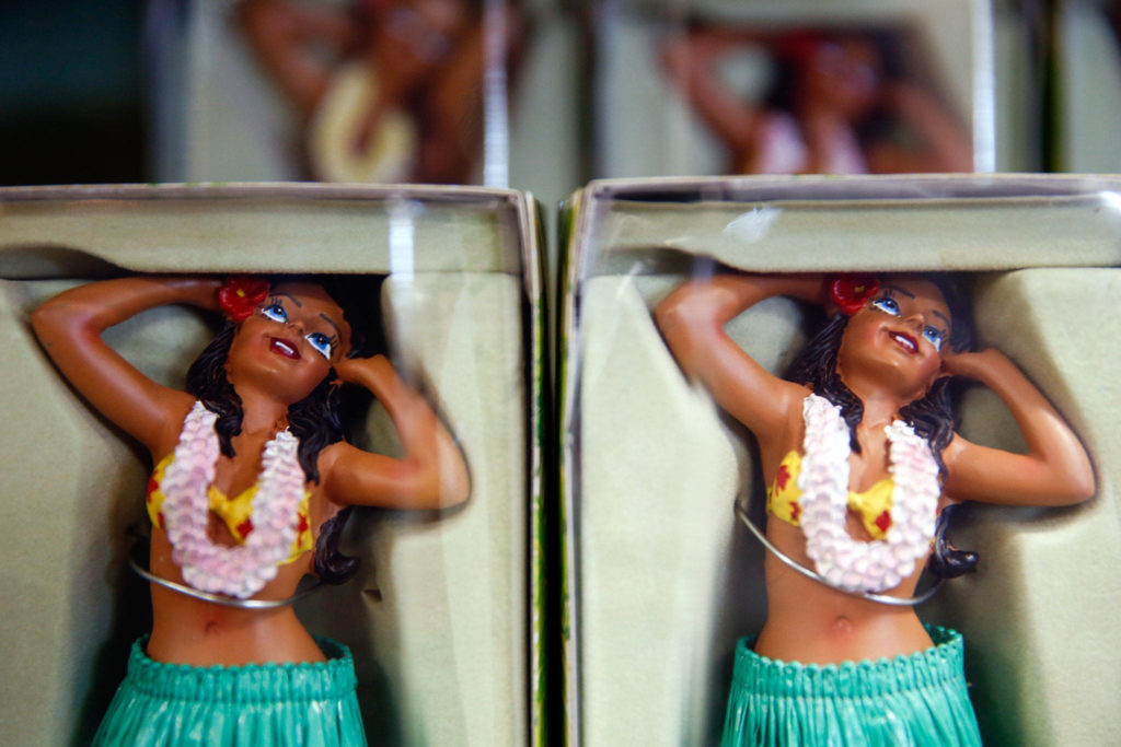You can buy figurines wearing grass skirts or actual grass skirts at The Colors of Hawaii gift store in Everett. (Kevin Clark / The Herald)
