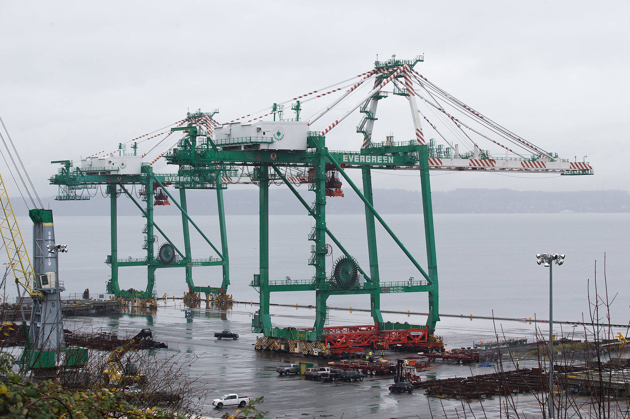 The last of two cranes is slowly moved into position at the Port of Everett’s South Terminal on Nov. 18 in Everett. (Andy Bronson / The Herald)