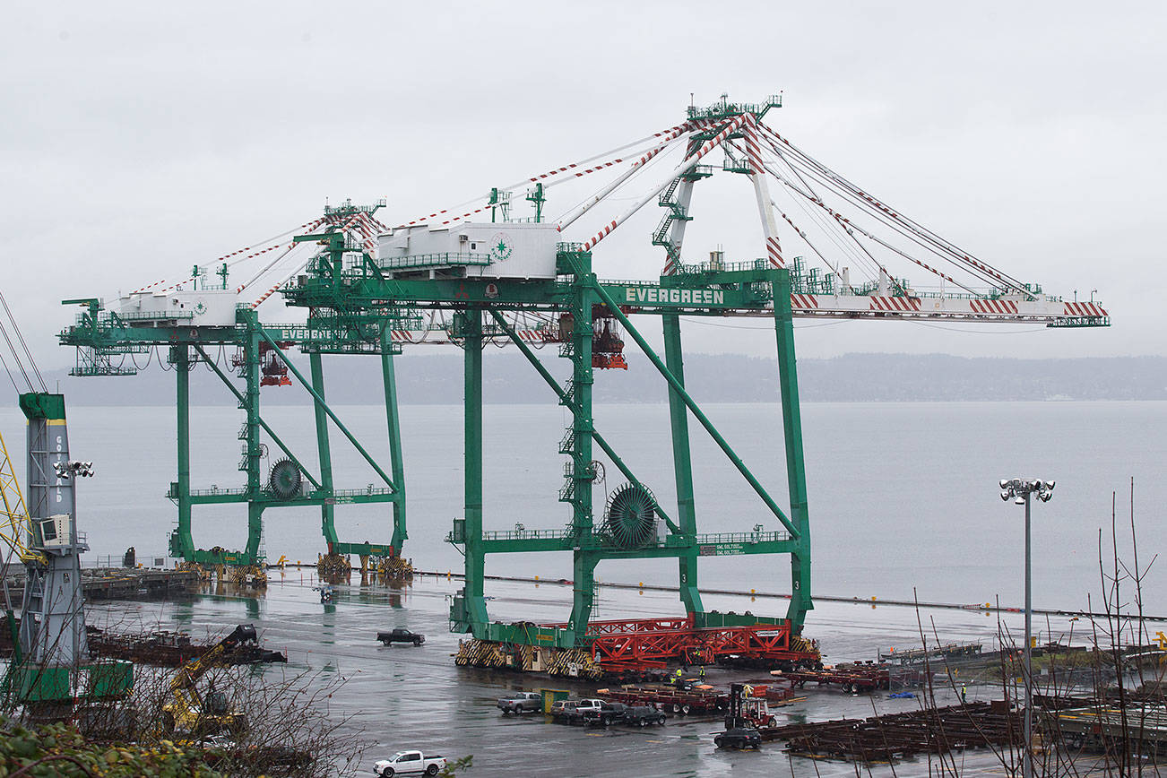 The last of two cranes is slowly moved into its final position on the Port of Everett's South Terminal on Wednesday, Nov. 18, 2020 in Everett, Washington.  (Andy Bronson / The Herald)
