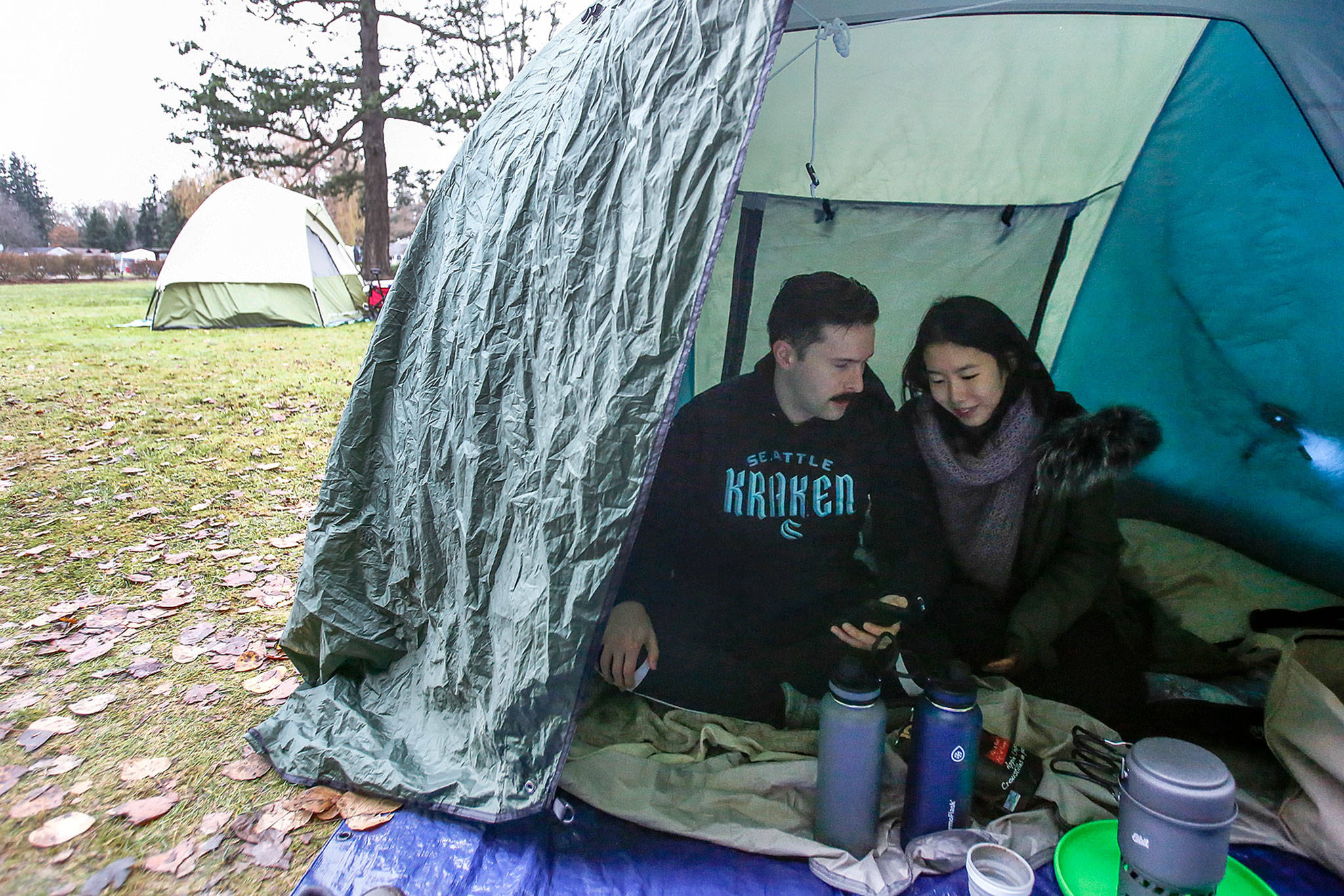 Each week, Bobby Warwick, a U.S. citizen, and Sarah Foo, of Canada, set up a makeshift tarp shelter at Peace Arch Historical State Park. (Kevin Clark / The Herald)