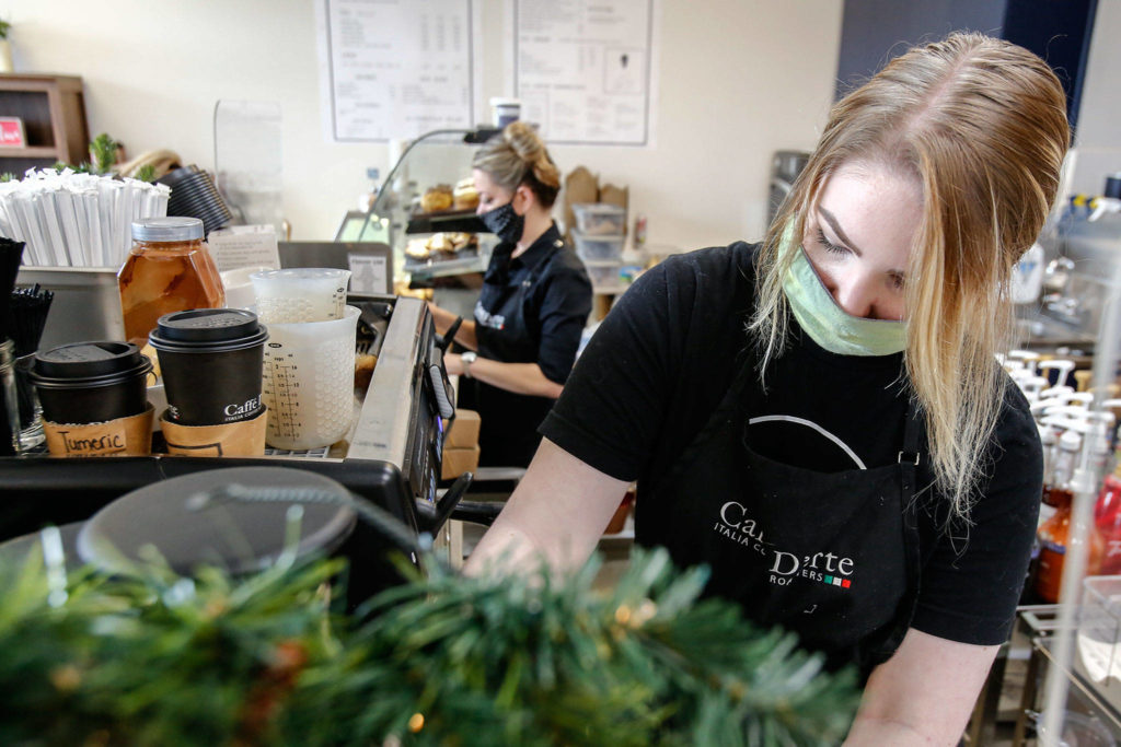 Delaney Fitze makes a drink order at Copper House Stanwood. (Kevin Clark / The Herald) 
