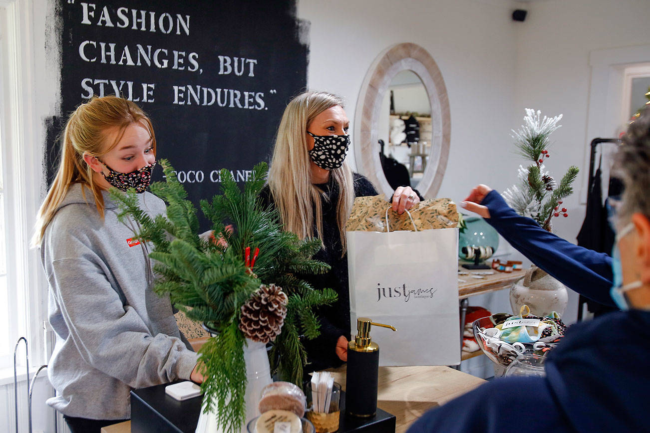 Claire Vondemkamp (left) and Jami Sollid check out customers Saturday afternoon at Just James Boutique in Stanwood on November 28, 2020. (Kevin Clark / The Herald)
