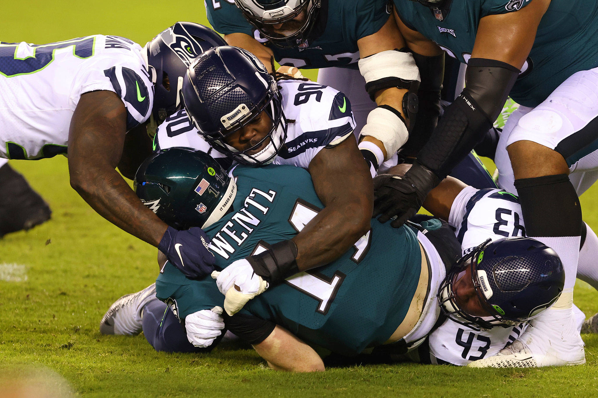 Eagles quarterback Carson Wentz (11) is sacked by the Seahawks’ Benson Mayowa (95), Jarran Reed (90) and Carlos Dunlap (43) during the first half of a game Nov. 30, 2020, in Philadelphia. (AP Photo/Rich Schultz)