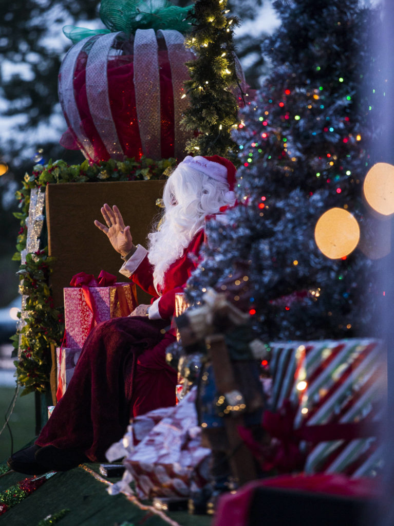 Santa Claus waves goodbye from his festive float during the socially distanced meet-up hosted by Maryfest on Thursday in Marysville. (Olivia Vanni / The Herald)
