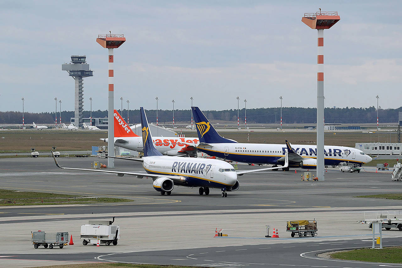 A Boeing 737-8AS aircraft, operated by Ryanair, taxis passed an EasyJet passenger jet at Schoenefeld airport in Berlin in 2019. (Krisztian Bocsi/Bloomberg)