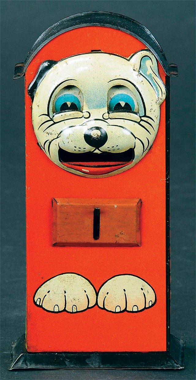 To deposit a coin in the Bonzo bank, you had to push his tummy. His tongue would come out of his mouth to deposit the coin inside. Many similar banks were made picturing other comic characters. (Cowles Syndicate Inc.)