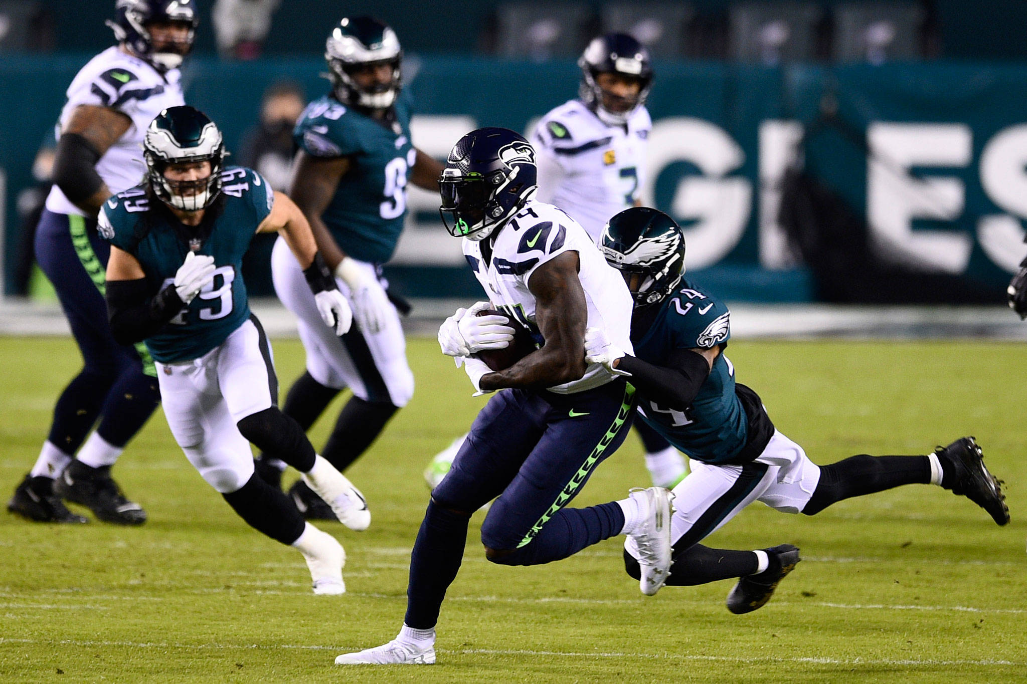 The Seahawks’ DK Metcalf (center) is tackled by the Eagles’ Darius Slay during the first half of a game Nov. 30, 2020, in Philadelphia. (AP Photo/Derik Hamilton)