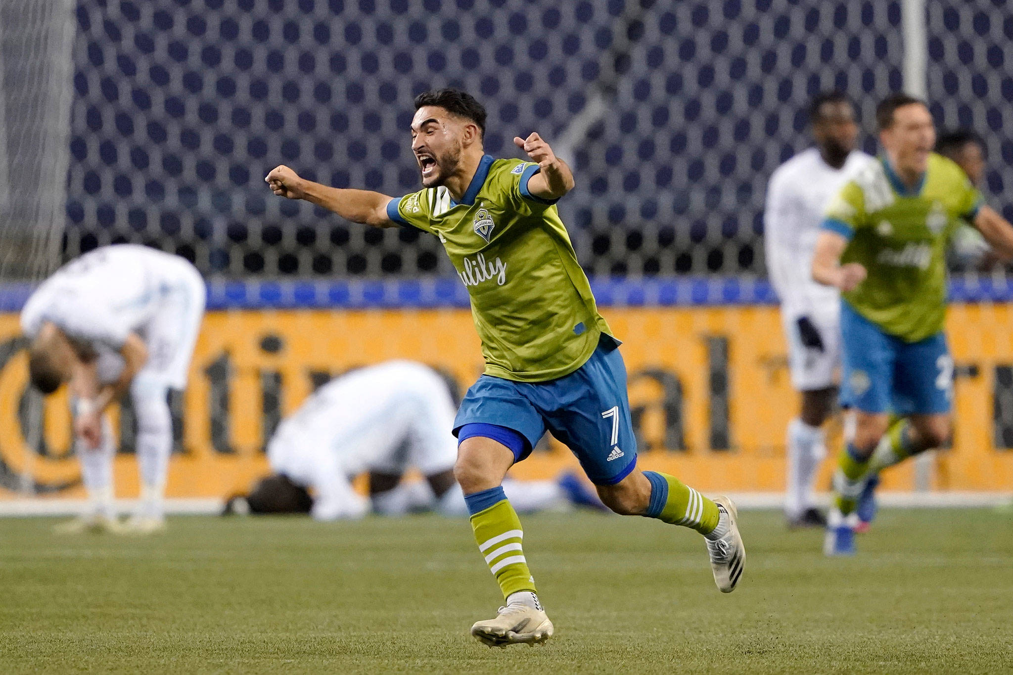 The Sounders’ Cristian Roldan (7) celebrates a Seattle goal late in the second half of an MLS playoff match against Minnesota United on Dec. 7, 2020, in Seattle. (AP Photo/Ted S. Warren)