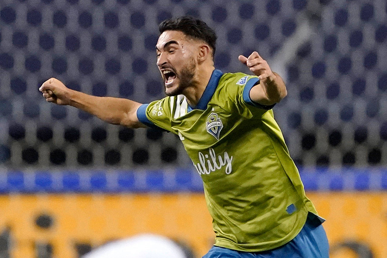 Seattle Sounders' Cristian Roldan (7) celebrates a Sounders goal late in the second half of an MLS playoff Western Conference final soccer match against Minnesota United, Monday, Dec. 7, 2020, in Seattle. The Sounders won 3-2. (AP Photo/Ted S. Warren)