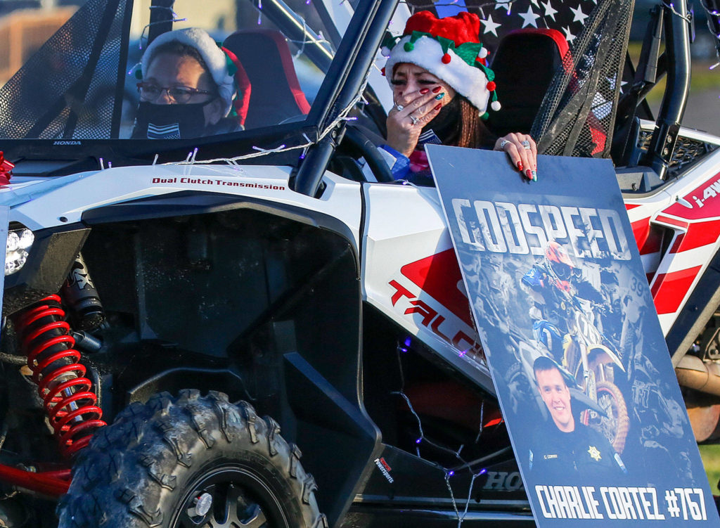 Christina Parker (right) and Roxanne Mitchell participate in a memorial parade for missing Tulalip officer Charlie Cortez Saturday afternoon on the Tulalip Reservation. (Kevin Clark / The Herald)
