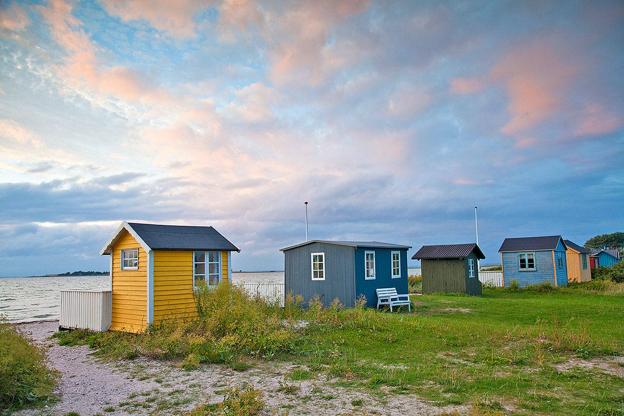 Tiny cabins line a beach on the Danish island of Aero. (Rick Steves’ Europe)
