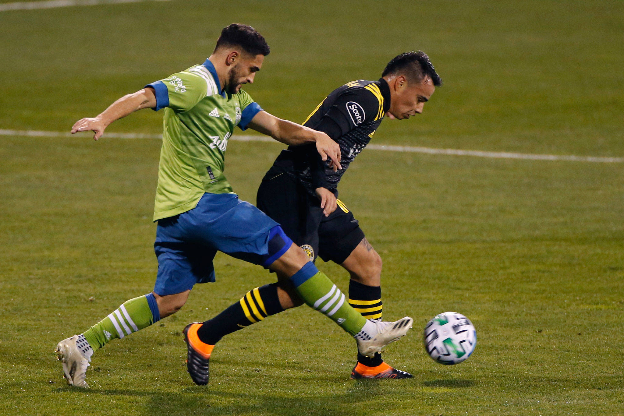 The Sounders’ Cristian Roldan (left) tries to dribble past the Crew’s Lucas Zelarayan during the first half of the MLS Cup championship match on Dec. 12, 2020, in Columbus, Ohio. (AP Photo/Jay LaPrete)