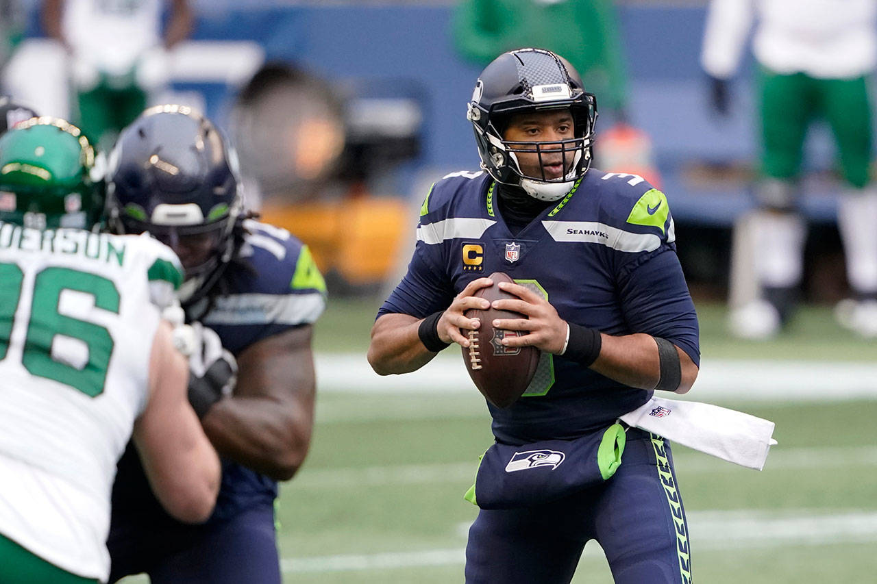 Seattle Seahawks quarterback Russell Wilson looks downfield against the New York Jets during the first half of Sunday’s NFL football game in Seattle. (AP Photo/Ted S. Warren)