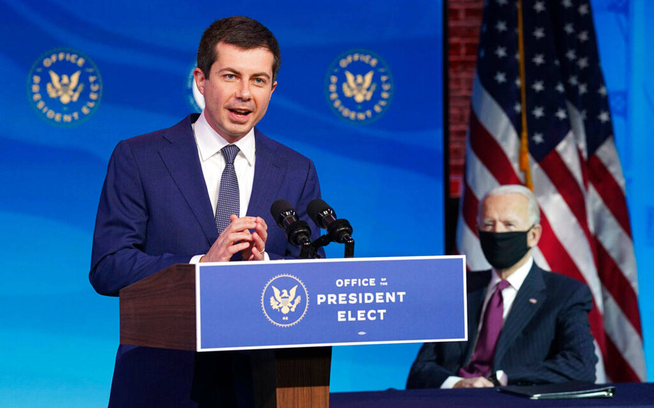 Former South Bend, Ind., Mayor Pete Buttigieg, President-elect Biden’s nominee to be transportation secretary speaks following his nomination as Biden looks on during a news conference at The Queen theater in Wilmington, Del., Wednesday. (Kevin Lamarque / Associated Press)