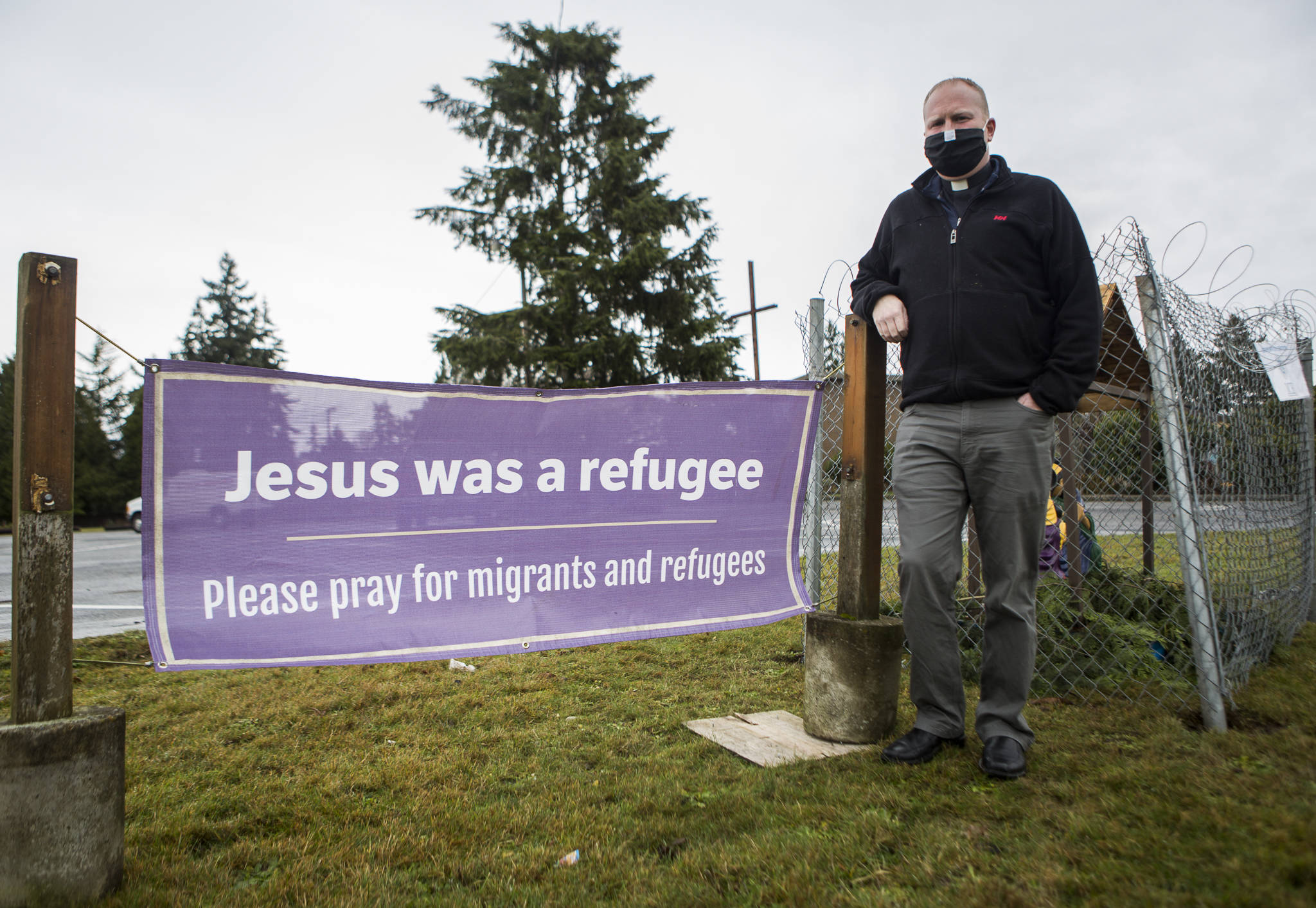 Pastor Tim Olseon, outside Edmonds Lutheran Church, where he has set up a Nativity surrounded by chain-link fence to shine a light on immigration issues. (Olivia Vanni / The Herald)