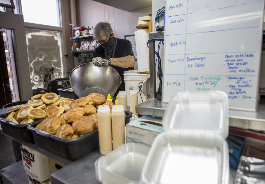 Vintage Cafe owner Jim Staniford puts together potato salad for meals Thursday in Everett. (Olivia Vanni / The Herald)
