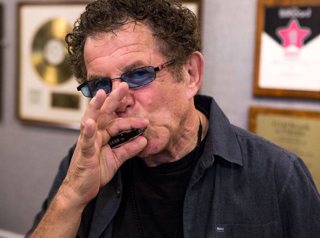Lee Oskar plays his harmonica at his Everett home. The musician, best known for playing in the 1970s funk-rock fusion band War, performed at a benefit concert for the Historic Everett Theatre. (Olivia Vanni / Herald file)
