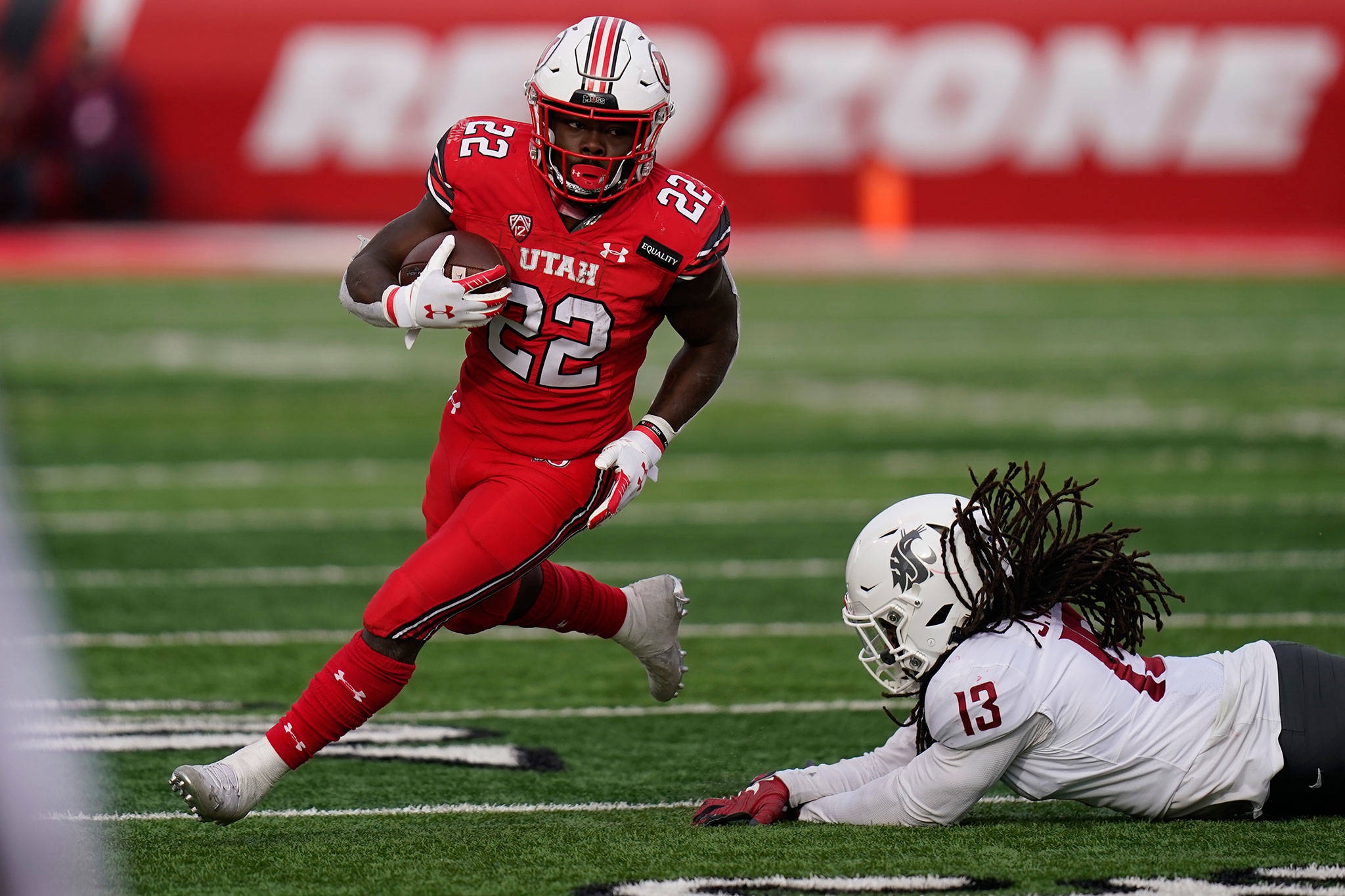 Utah running back Ty Jordan (22) runs for a score as he eludes a tackle by Washington State linebacker Jahad Woods (13) during the second half of a game Dec. 19, 2020, in Salt Lake City. (AP Photo/Rick Bowmer)