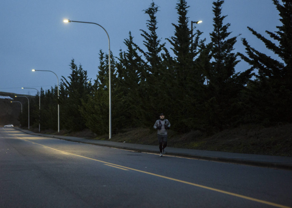 Wes Plate, 47, runs along Associated Boulevard during a 12 mile run through Everett on Sunday, Dec. 20, 2020. (Olivia Vanni / The Herald)
