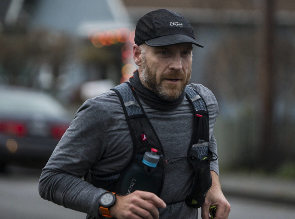 Wes Plate runs along Federal Avenue on Sunday, Dec. 20, 2020 in Everett. (Olivia Vanni / The Herald)
