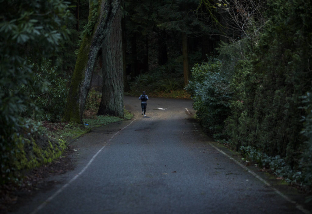 Wes Plate runs down Park Road through Forest Park on Sunday, Dec. 20, 2020 in Everett. (Olivia Vanni / The Herald)
