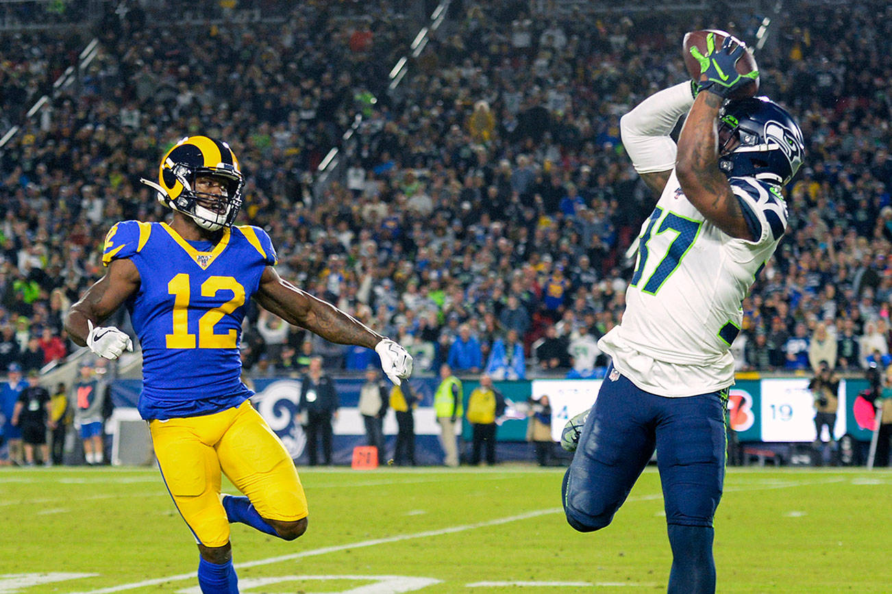 Readers are picking Quandre Diggs (right) and the Seattle Seahawks to beat the Los Angeles Rams on Sunday at Lumen Field in a game that could decide the NFC West. (AP Photo/Kyusung Gong)