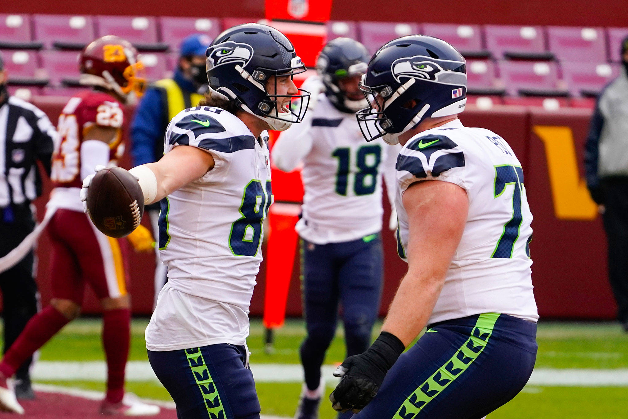 Seahawks tight end Jacob Hollister (left) celebrates his touchdown with center Ethan Pocic (right) during the first half of a game against Washington on Dec. 20, 2020, in Landover, Md. (AP Photo/Andrew Harnik)