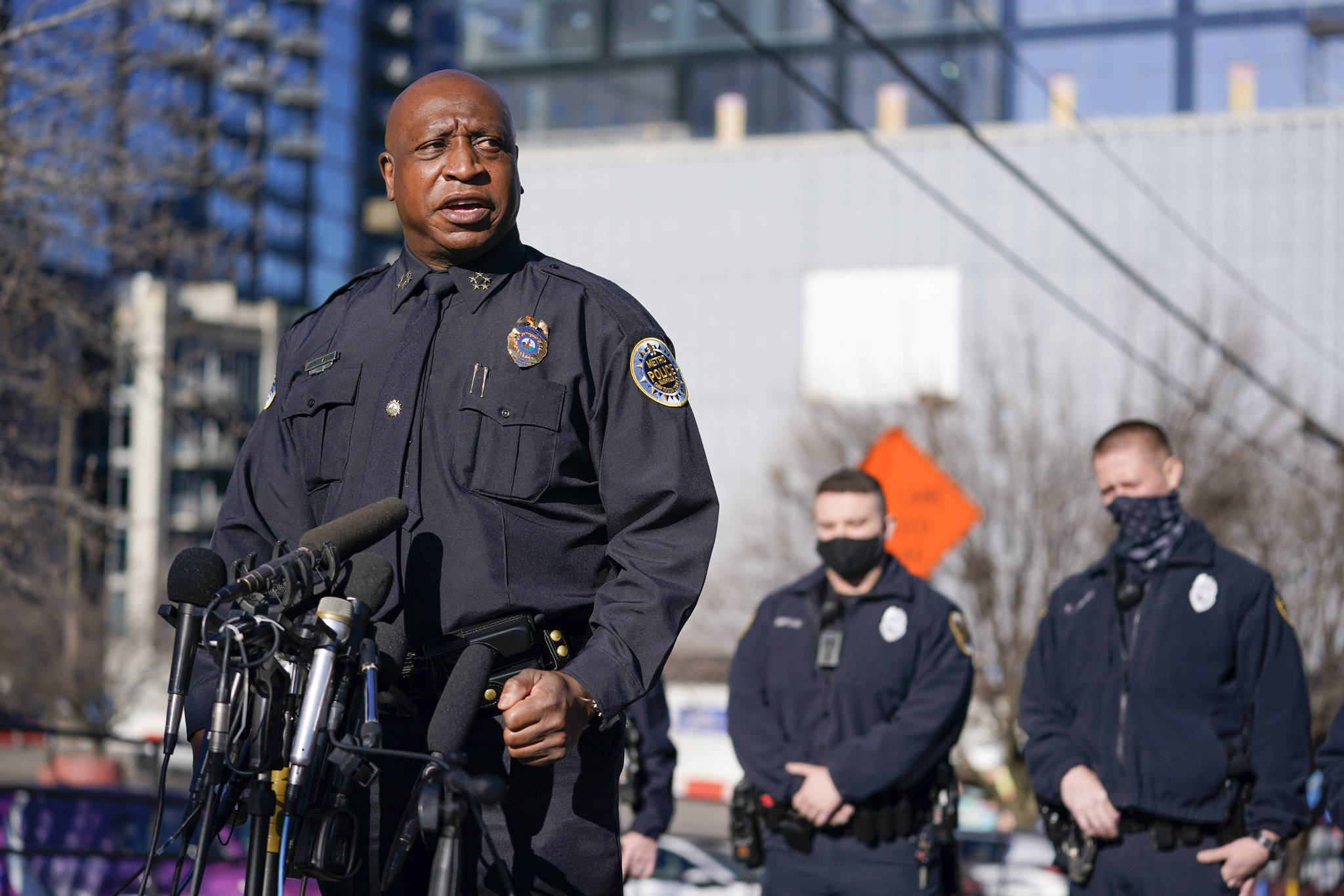 Nashville Chief of Police John Drake speaks at a news conference Sunday, Dec. 27, 2020, in Nashville, Tenn. Drake spoke before five officers told what they experienced when an explosion took place in downtown Nashville early Christmas morning. The officers are part of a group of six officers credited with evacuating people before the explosion happened. Behind Drake are two of the officers, Michael Sipos, center, and Richard Luellen, right. (AP Photo/Mark Humphrey)