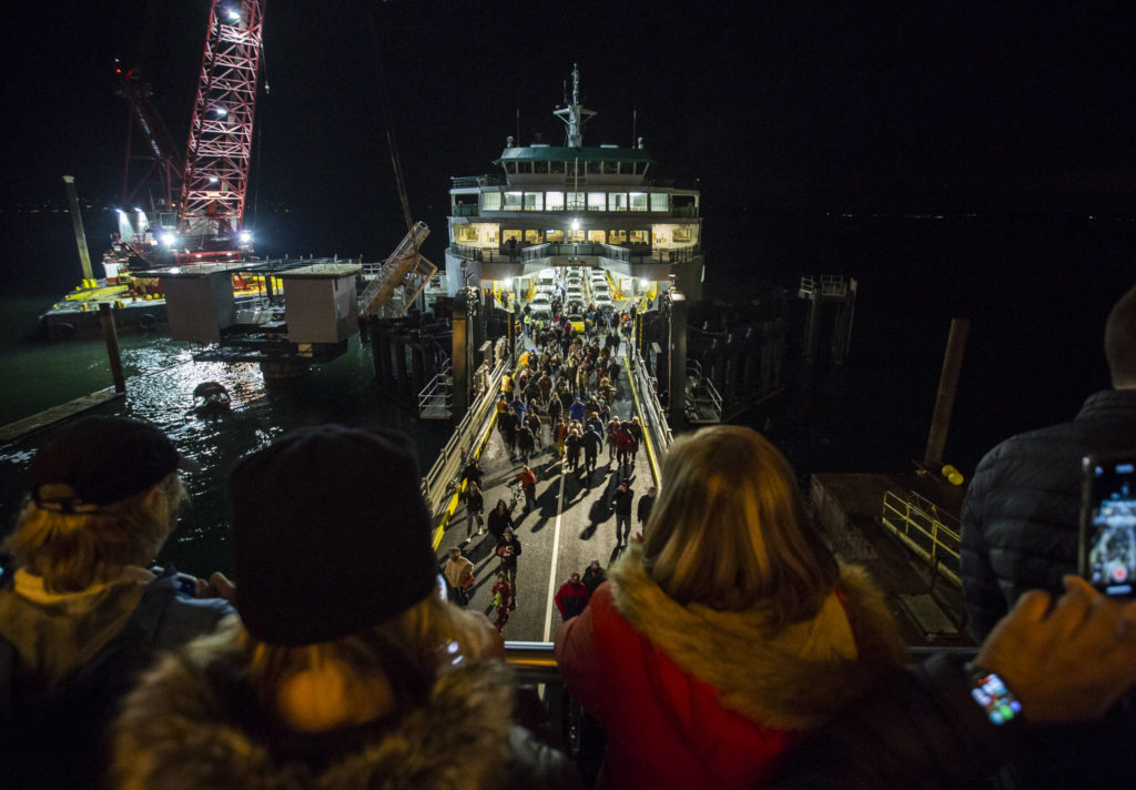 People at the new Mukilteo ferry terminal cheer as the first passengers off-load on Tuesday. (Olivia Vanni / The Herald) 
