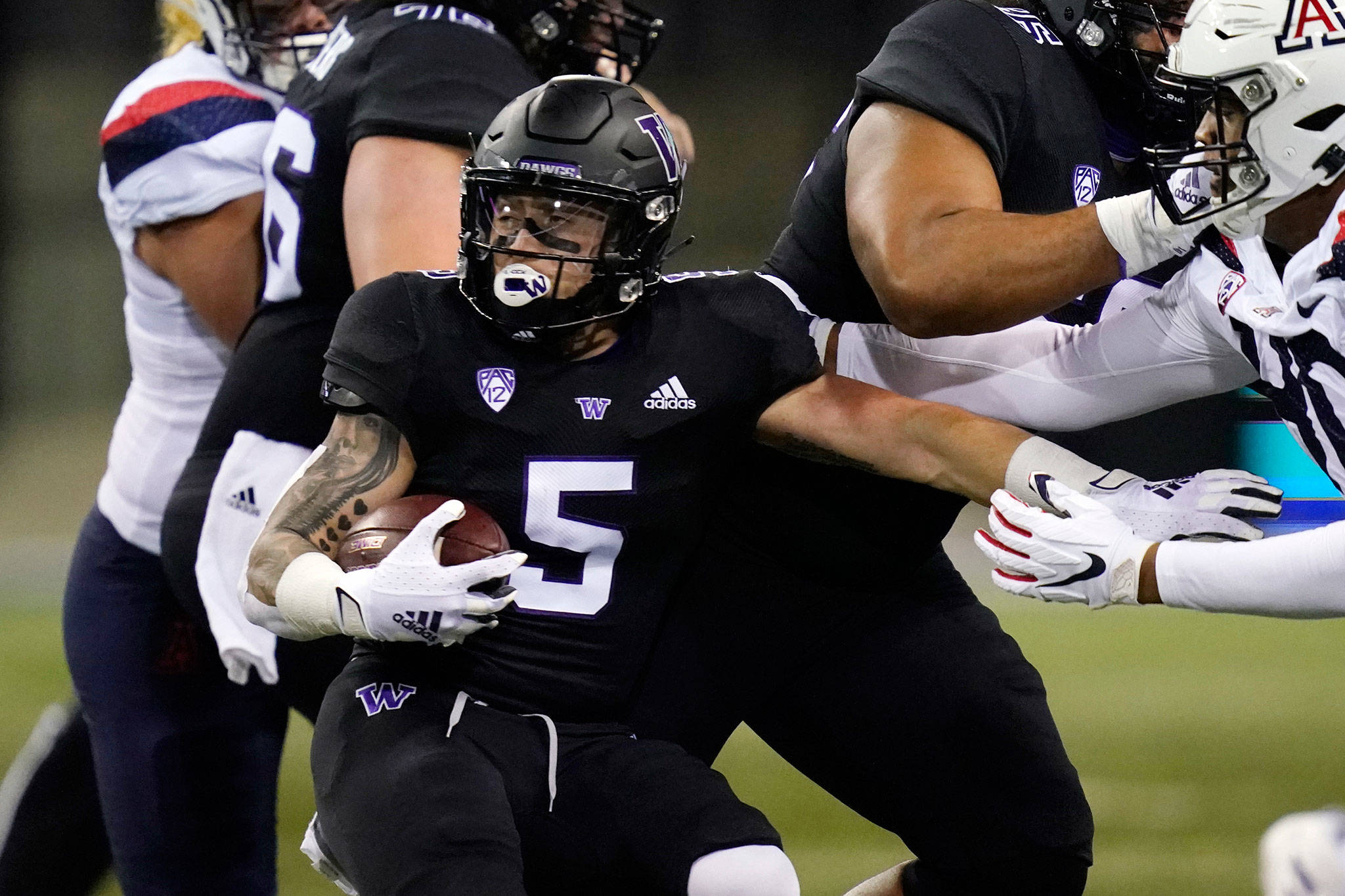 Washington running back Sean McGrew carries during the first half of a game against Arizona on Nov. 21, 2020, in Seattle. (AP Photo/Elaine Thompson)