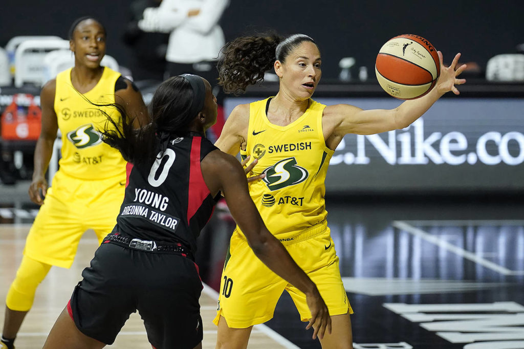 Seattle Storm guard Sue Bird (10) grabs the ball away from Las Vegas Aces guard Jackie Young (0) during Game 3 of basketball’s WNBA Finals on Oct. 6 in Bradenton, Florida. The Storm winning the league championship, with the biggest margin of victory in WNBA Finals and the fourth title for the franchise, was among Washington state’s top stories for 2020. (AP Photo/Chris O’Meara, File)
