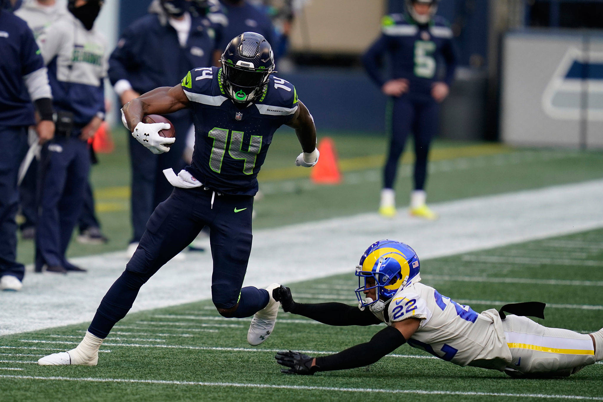 Seahawks wide receiver DK Metcalf (14) runs past Rams cornerback Troy Hill (22) during the first half of a game Dec. 27, 2020, in Seattle. (AP Photo/Elaine Thompson)
