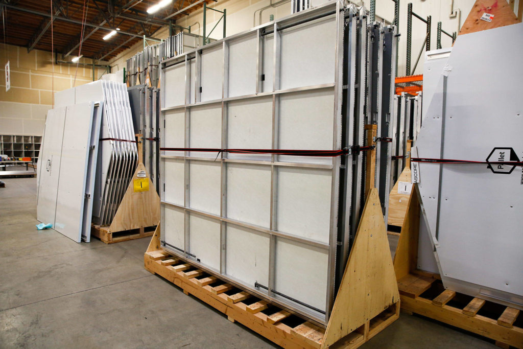 Shelters await shipping and assembly at Pallet in Everett. (Kevin Clark / The Herald)
