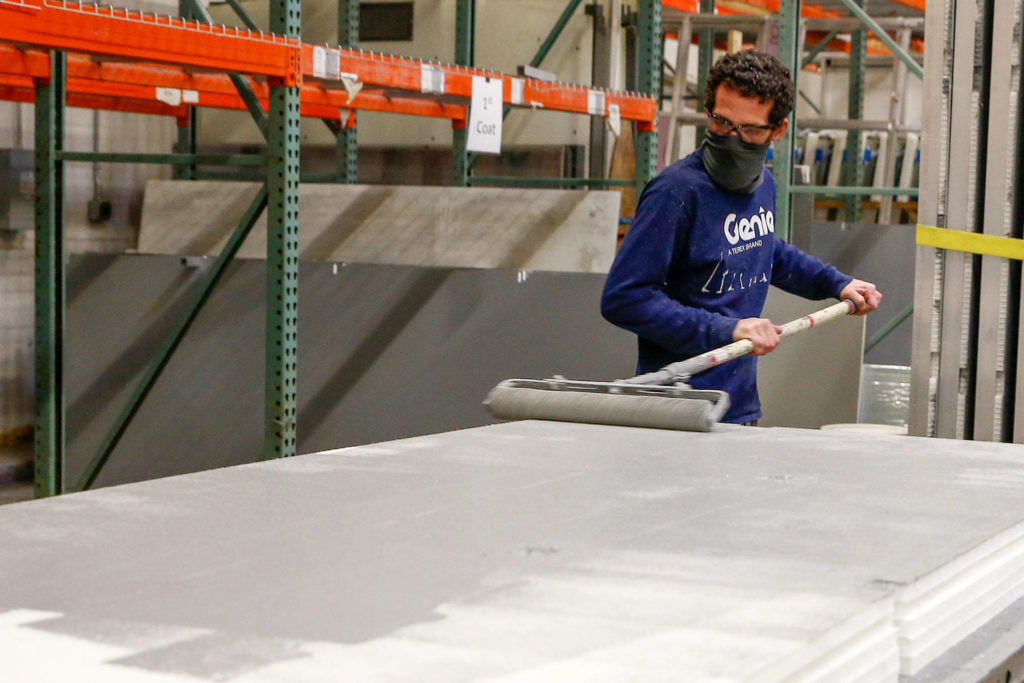 Floors are painted as part of the fabrication process at Pallet in Everett. (Kevin Clark / The Herald)
